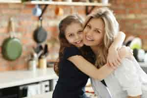 Free photo mother and daughter hugging