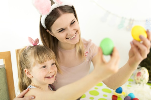 Mother and daughter looking at decorated eggs