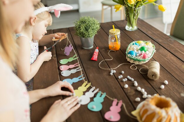 Mother and daughter making garland