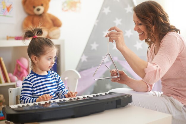 Mother and daughter playing music and singing