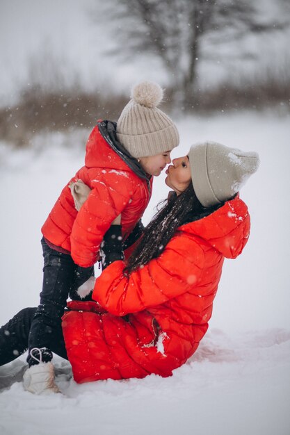 Mother and daughter playing in winter park