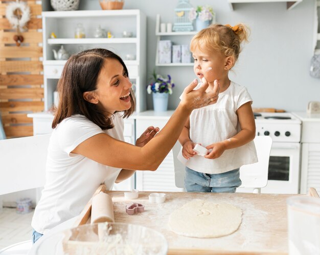 Mother and daughter playing with flour