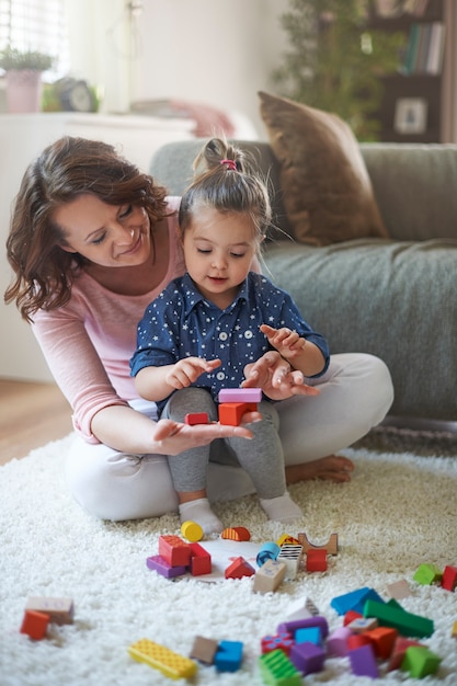 Mother and daughter playing with toys