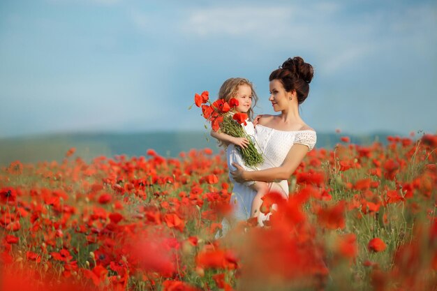 mother and daughter in poppy field