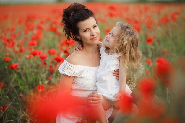 mother and daughter in poppy field