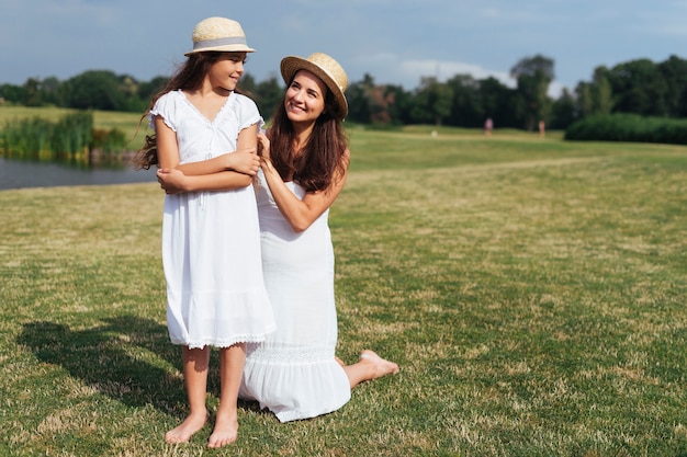 Mother and daughter posing outdoors 