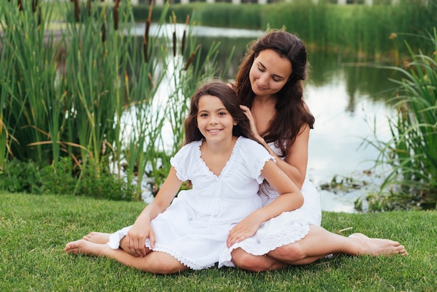 Mother and daughter posing outdoors