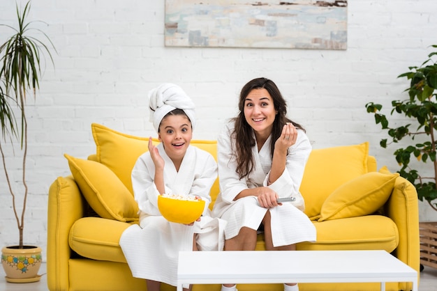 Free photo mother and daughter posing in robes