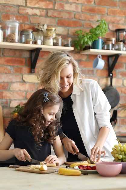 Mother and daughter preparing breakfast