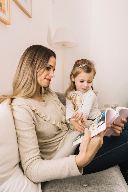 Free photo mother and daughter reading comic book