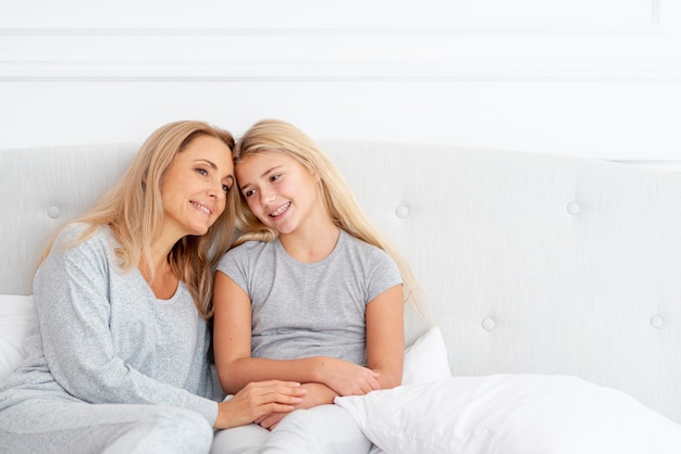 Mother and daughter resting in bedroom