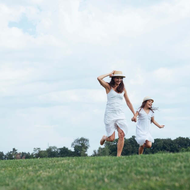 Mother and daughter running outdoors