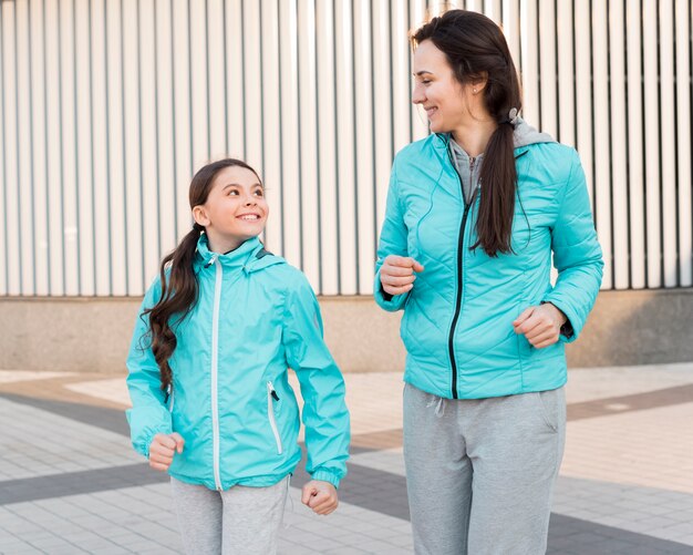 Mother and daughter running together