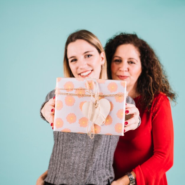 Mother and daughter showing gift