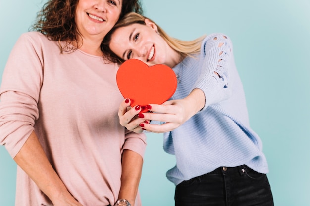 Mother and daughter showing heart