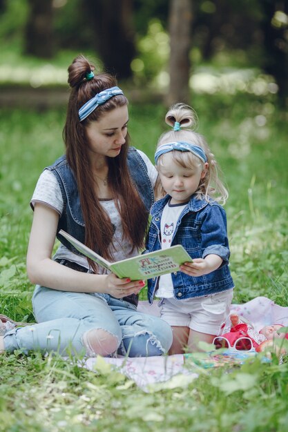 Mother and daughter sitting on the floor reading a story