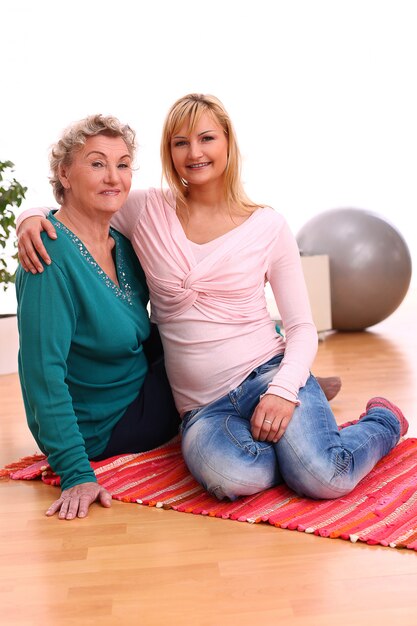 mother and daughter sitting on the floor