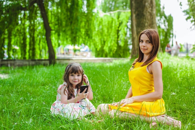 Mother and daughter sitting in a park