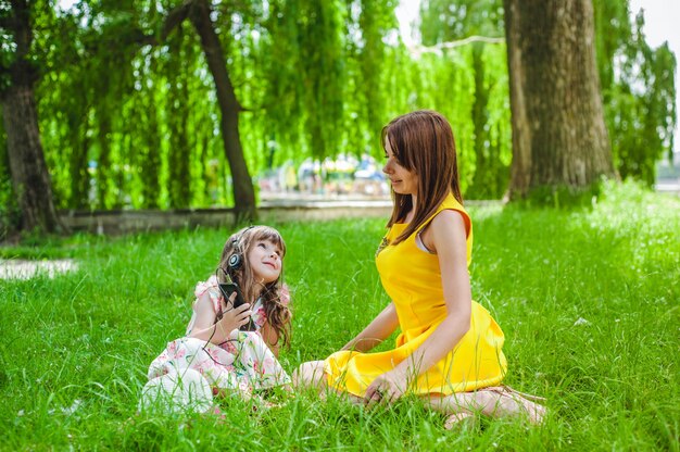 Mother and daughter sitting in a park