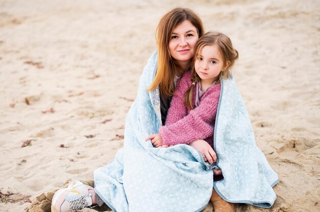 Mother and daughter snuggling front view