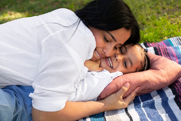 Free photo mother and daughter spending time together outside at the park for mother's day