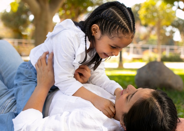 Mother and daughter spending time together outside at the park for mother's day