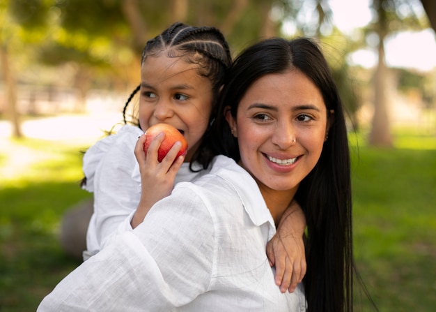 Mother and daughter spending time together outside at the park for mother's day