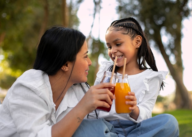 Mother and daughter spending time together outside at the park for mother's day