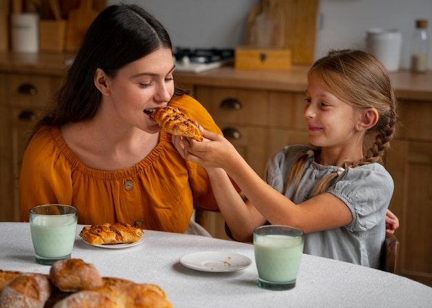 Free photo mother and daughter spending time together while wearing linen clothing