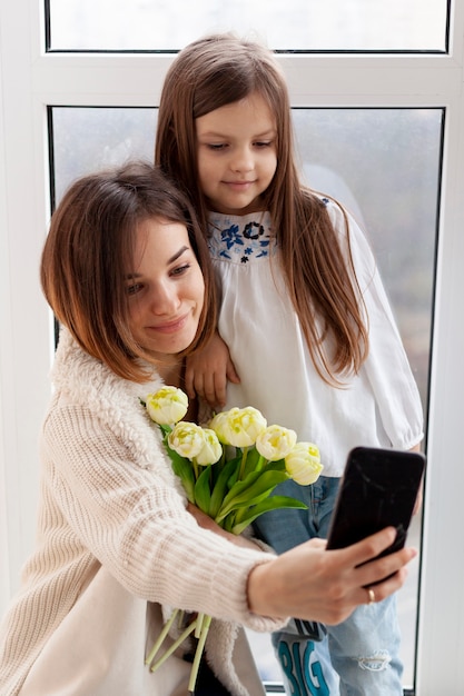 Mother and daughter taking selfie