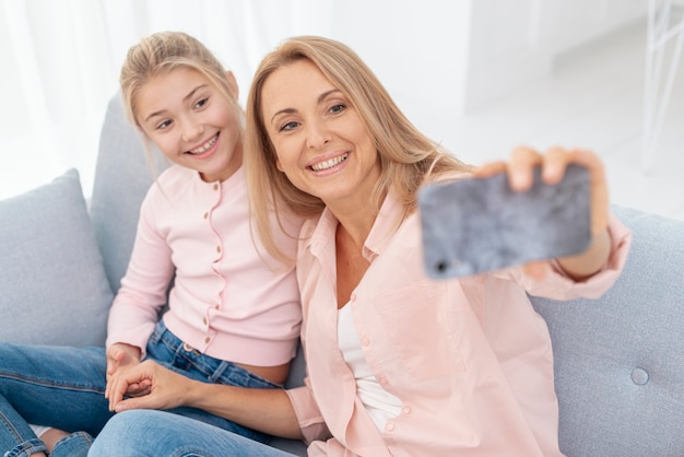 Mother and daughter taking selfies