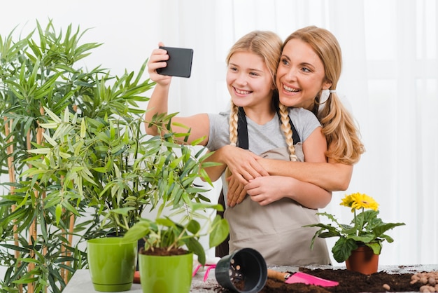 Mother and daughter taking selfies