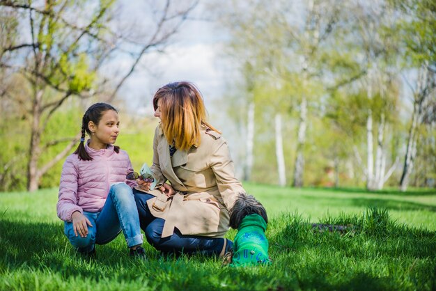 Mother and daughter talking in the park