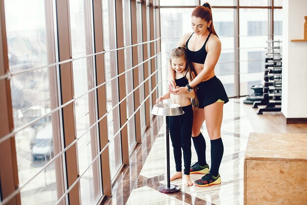 Mother and daughter training in a gym