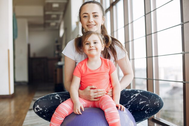 Mother and daughter training in a gym