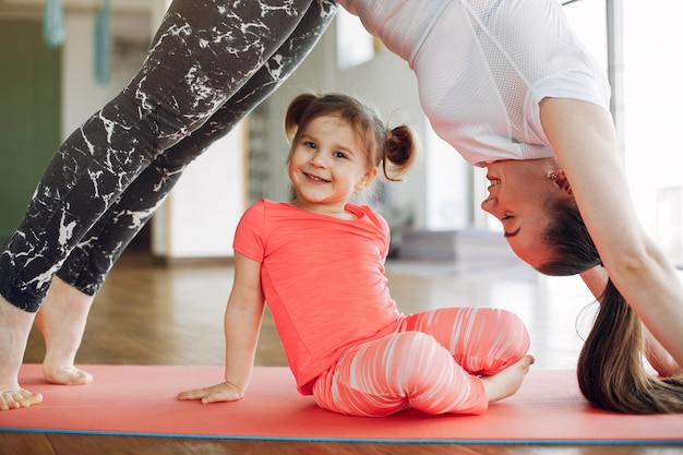 Mother and daughter training in a gym
