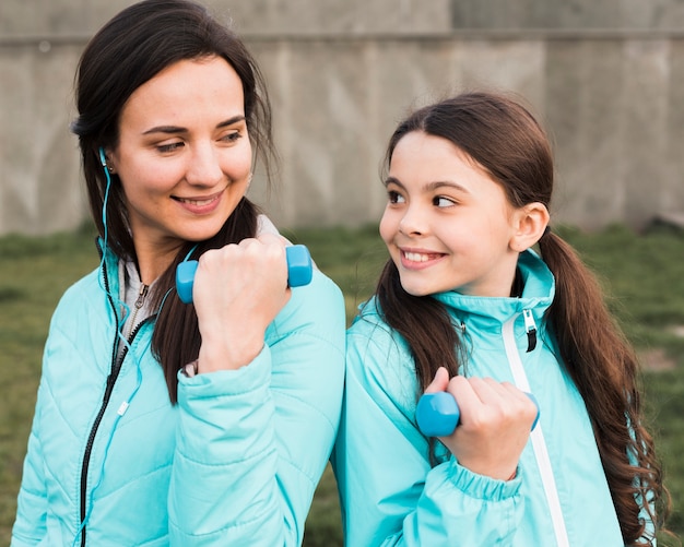 Free photo mother and daughter training outside