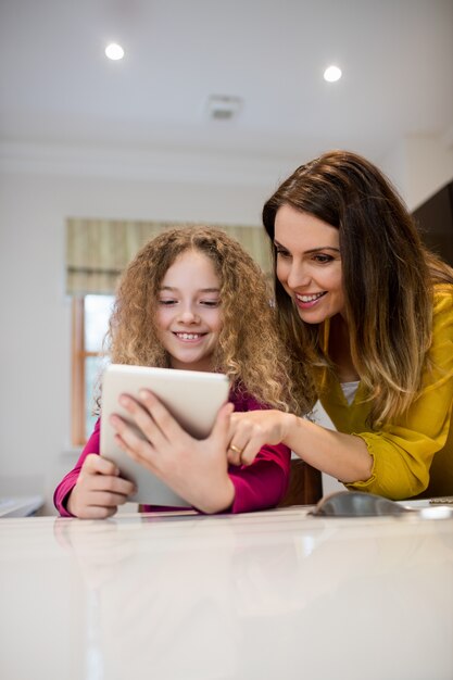 Mother and daughter using digital tablet