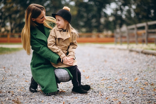 Mother and daughter walking around the stable