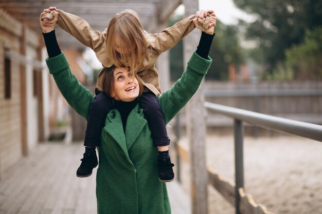 Free photo mother and daughter walking around the stable