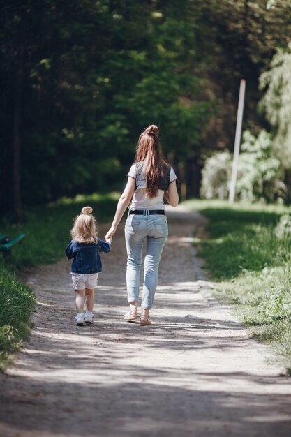 Mother and daughter walking on a dirt road