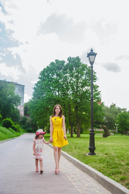 Mother and daughter walking on a path with cobblestones