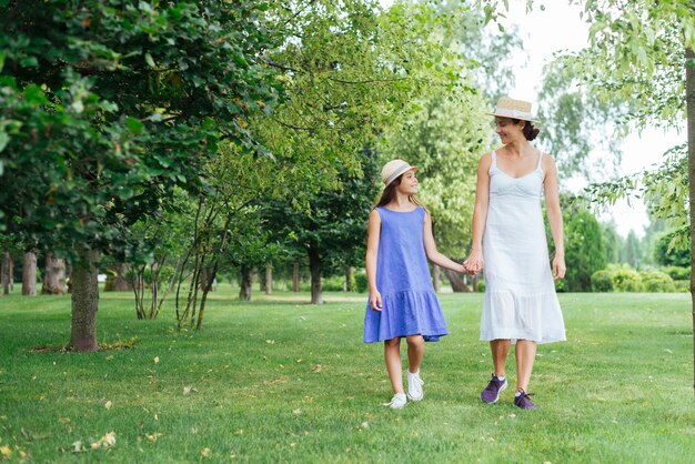 Mother and daughter walking together outdoors