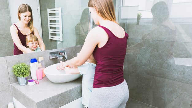 Mother and daughter washing hands