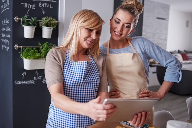 Mother and daughter watching recipe on a tablet