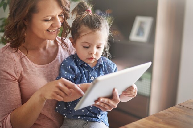 Mother and daughter watching videos together