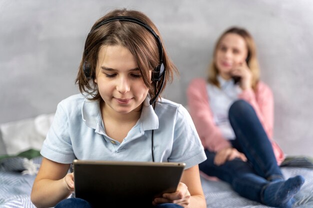 Mother and daughter with devices