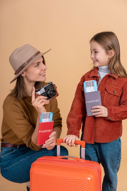 Mother and daughter with luggage ready for traveling