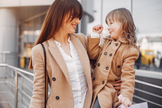 Mother and daughter with shopping bag in a city