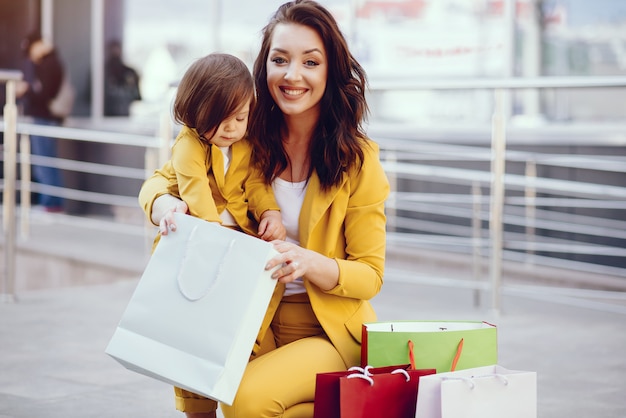 Mother and daughter with shopping bag in a city